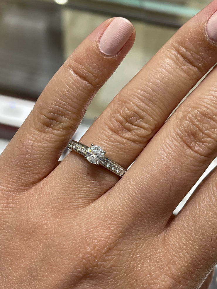 Solitaire side stone engagement ring deals